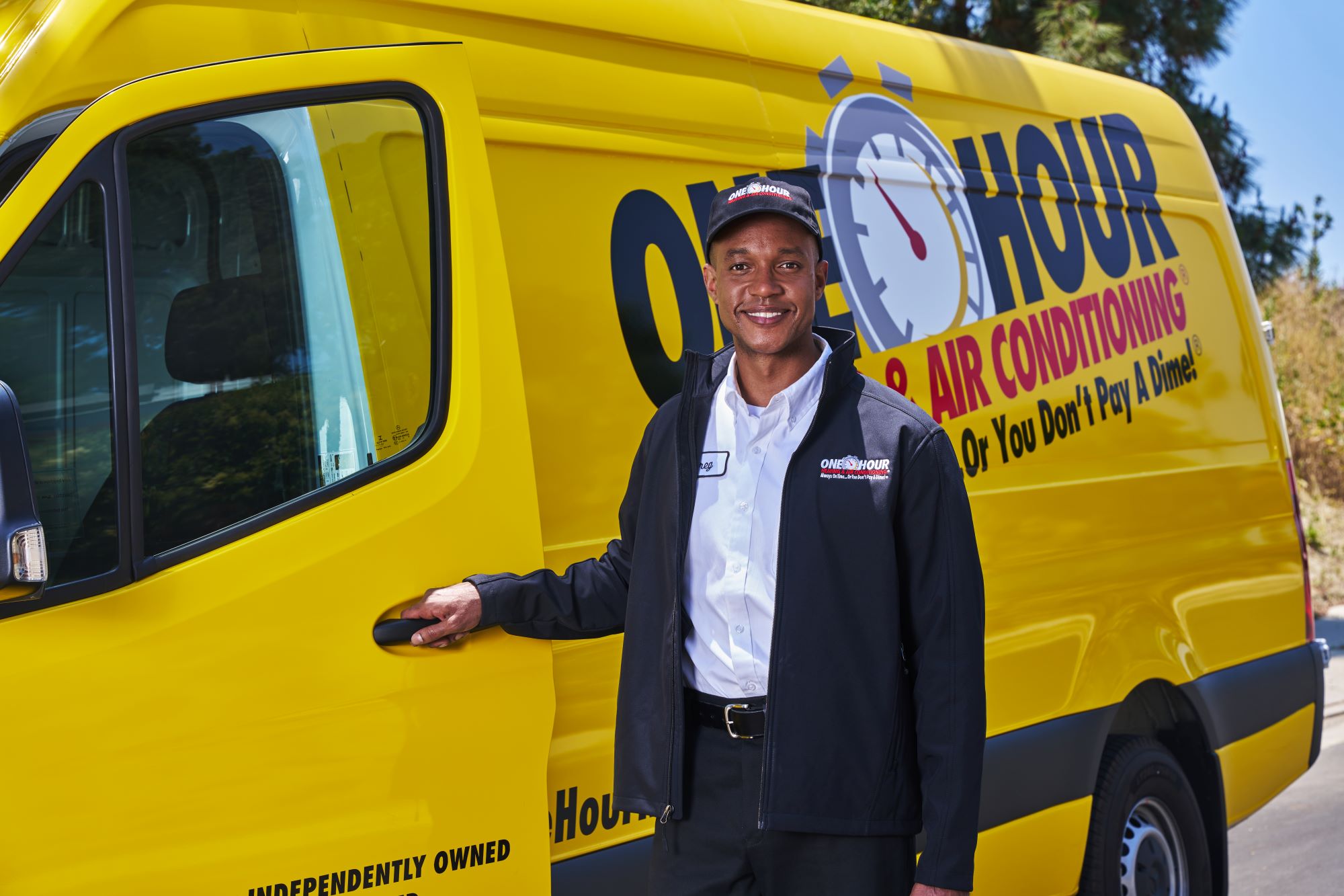 HVAC business owner opening door to One Hour branded truck.