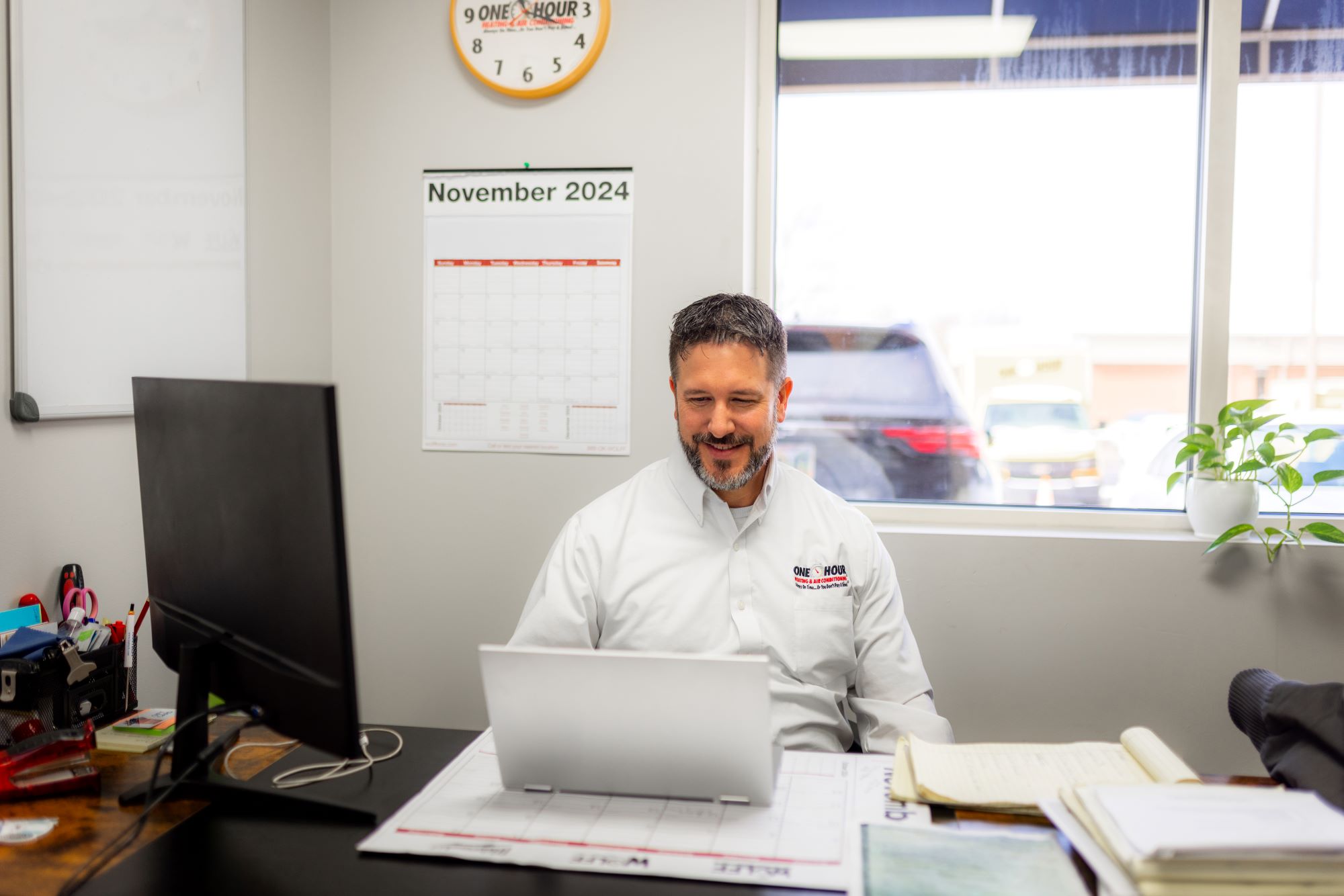One Hour HVAC small business owner working at a desk.